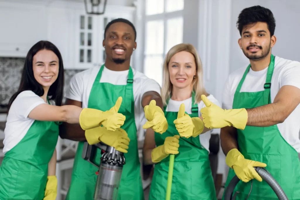 Professional team of bi-weekly cleaners smiling at the camera
